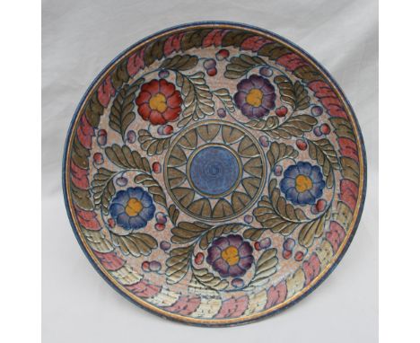 A Crown Ducal pottery charger decorated with purple, blue and red flowers to a mottled orange ground, printed mark, No.5803, 