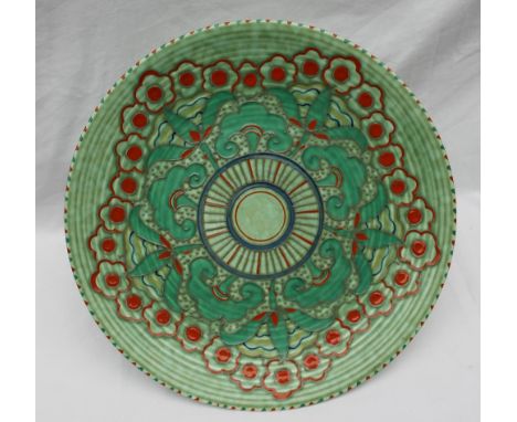 A Crown Ducal, Charlotte Rhead pottery charger decorated with orange and green flowers to a green ground, printed mark, signe