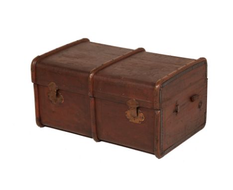 A LARGE VINTAGE BRASS AND BOUND CANVAS TRAVELLING TRUNK
A brown canvas travelling trunk with wooden and two brass lock plates
