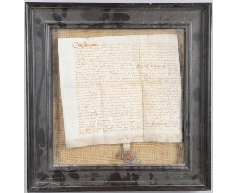 An Elizabeth I indenture manuscript, hand written on a single sheet of vellum, with wax seal attached below, framed and glaze