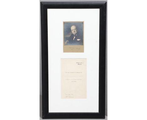 Winston Churchill (1874-1965). A black and white photographic portrait, the subject seated at a desk, signed to mount, togeth