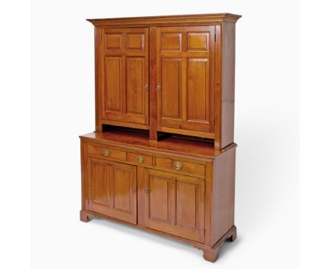 Late 18th centuryThe upper section with cupboard doors surrounded by beaded moldingon a lower section of three short drawers 