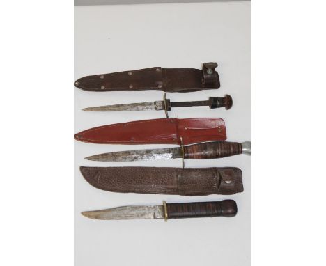 Three vintage sheath knives in various condition with correct sheaths 