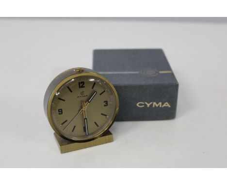 A vintage Cyma travel alarm clock 
