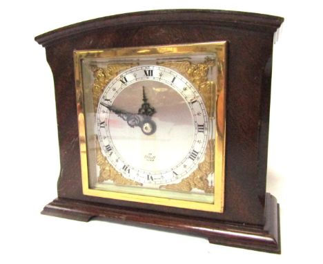 An Elliott mantel clock, in mahogany case, with a square set dial, with cherub gold spandrels and a silvered dial with Roman 