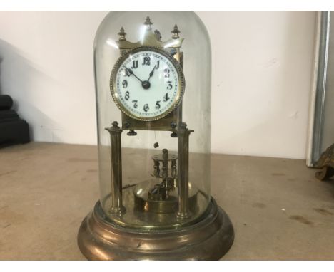 A Anniversary clock under glass dome .