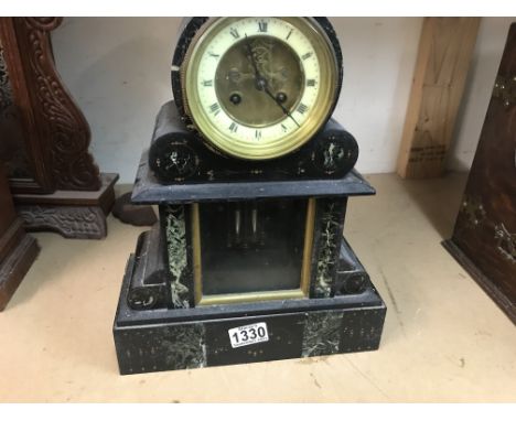 A marble slate marble mantle clock the circular dial with visible escapement and pendulum.