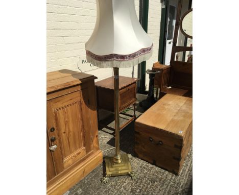An Antique brass lamp base in the form of a Corinthian column with a stepped rectangular base on claw feet. Height 165cm