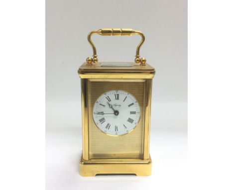 An Asprey laqcuered brass mantle clock, approx height 18cm including handle. Shipping category D.