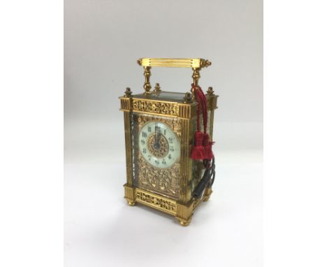 A brass cased carriage clock with engraved front. Comes supplied with keys. Shipping category D.