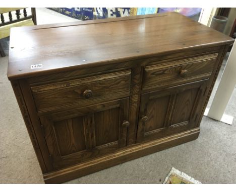 A Quality Ercol cabinet the rectangular top above two drawers with cupboards under on a plinth base. 98cm wide 49cm wide.