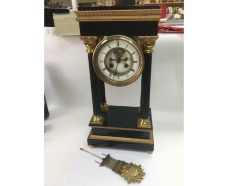 An ebonised four pillar eight day mantle clock, approx height 47cm. Shipping category D.