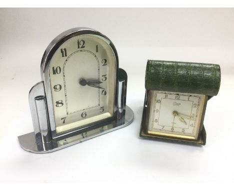 An Art Deco style chrome clock and a folding travel clock (2). Shipping category D.