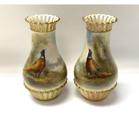 A matching pair of Royal Worcester pierced rim Pheasant vases, painted by JAS Stinton. 13.5cm (Restored) Cat D.