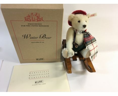 A limited edition Steiff bear with wooden sledge in box with certificate. Postage B