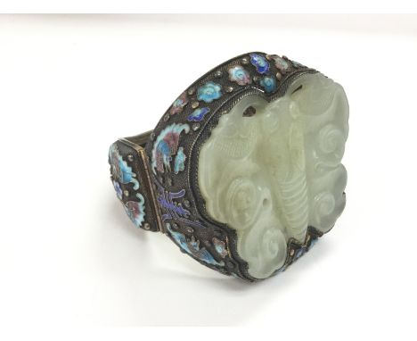 A large silver and jade bangle carved in the form of a butterfly with cloisonne decoration. Shipping category B.