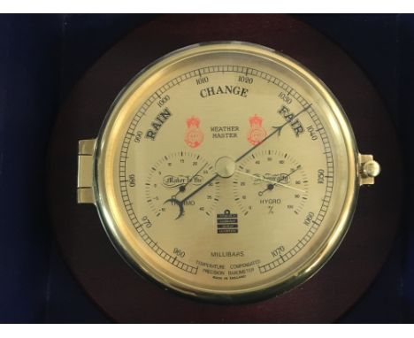 A brass ships barometer. Made in England by sewills of London. Mounted on wooden plaque and in original box. Postage C.