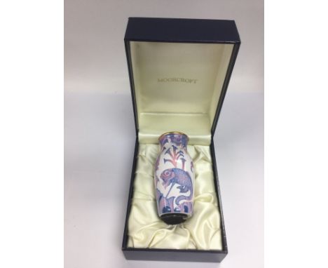 A small boxed Moorcroft enamel vase depicting fish, approx height 9.5cm. Shipping category D.