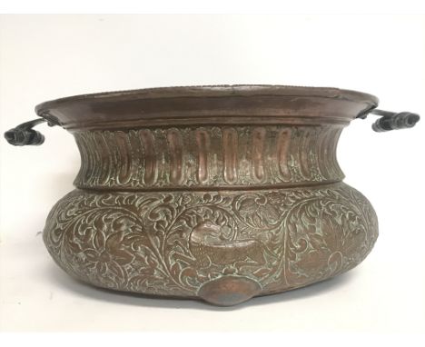 A Large vintage copper pressed planter decorated with various animals and floral patterns. 52cm wide, 22cm tall. Postage cate