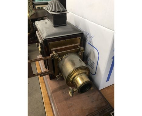 A magic lantern with brass lens and glass slides .