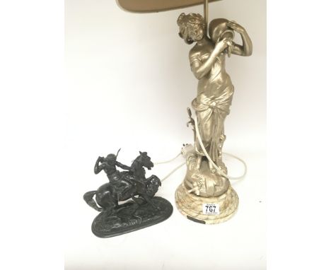 A Spelter figure of an Indian on horse back being attacked by a cougar and a painted spelter lamp in the form of a maiden. (2