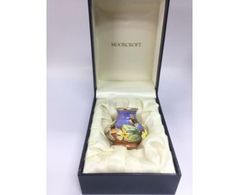 A small boxed Moorcroft enamel vase decorated with bees and flowers, approx 4.5cm. Shipping category D.