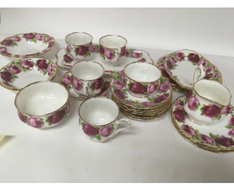 A Royal Albert Old English Rose part tea and dinner service four cups saucers bowls and plates.