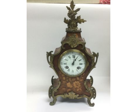 A French walnut marquetry mantle clock by Maple & Co, Paris. Approx height 37.5cm. Shipping category D.