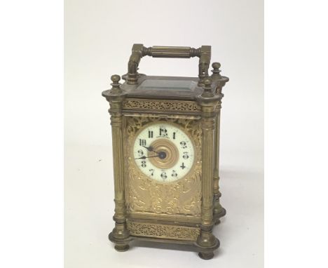 An ornate brass Mappin and Webb carriage clock early 20th century with four content pillars elaborate blind fretwork decorati