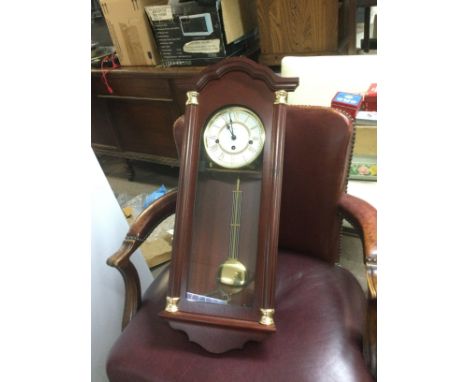 A reproduction wall clock and a brass clock under a dome (2). Shipping category D.