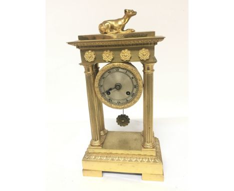 A Quality French four pillar brass clock second Empire the top,surmounted with a dog silk suspension movement striking on a b