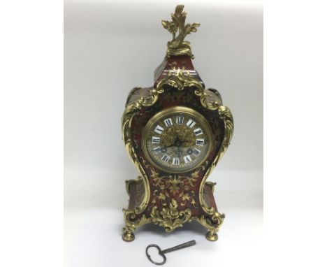 A French tortoiseshell and brass inlaid boulle clock, approx height 36cm. Comes supplied with a key. Shipping category D.