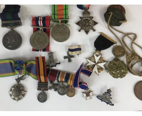 A First World War medal 1914- 1915 star PTE H smith Lincoln R miniature medals Second World War medals Cap badges.