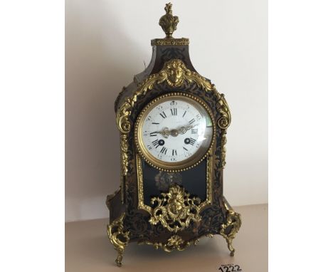 A French Boulle work clock with a white enamel dial the movement striking on a bell. Height 38cm