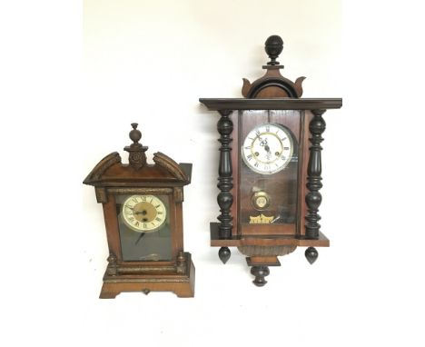 A Continental wall clock (needs restoring) and one other walnut clock, with keys postage category D