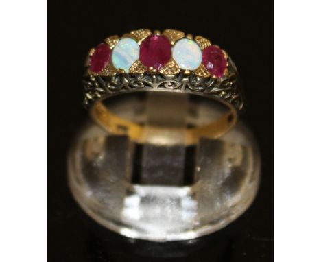 A RUBY AND OPAL VICTORIAN STYLE RING, three rubies and two opals, set in 9ct gold.