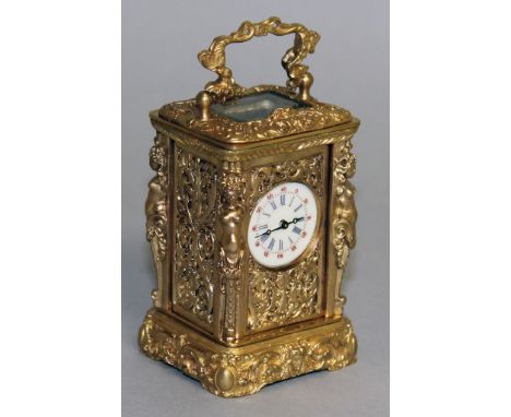 A MINIATURE CAST ORMOLU CARRIAGE CLOCK. 7cms high.