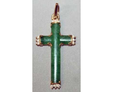 A JADE DIAMOND SET CROSS in high grade gold.