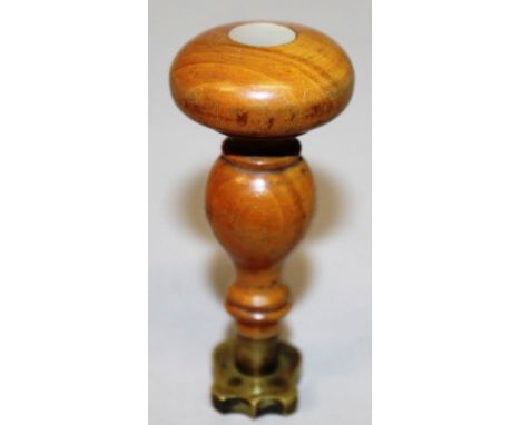 A WOODEN HANDLED DESK SEAL, with shield shaped armorial incised intaglio and simply turned wooden grip, set with a circular m