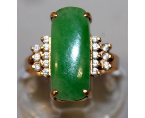 A GOOD GOLD, JADE AND DIAMOND RING, central jade with two rows of diamond to the shoulders.