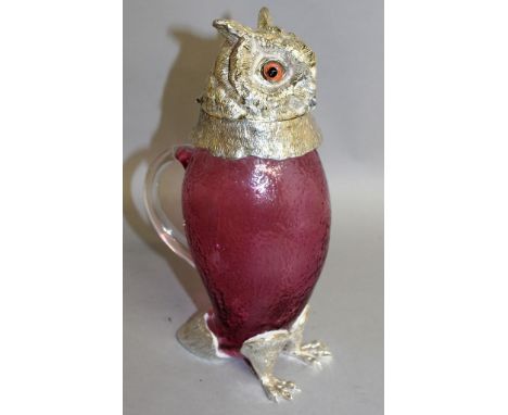 A GOOD RUBY GLASS AND PLATE OWL CLARET JUG with plate band, head, glass eyes and feet.  11ins high.