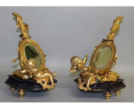 A VERY GOOD PAIR OF LOUIS XVI DESIGN ORMOLU CUPID MIRRORS formed as a banjo with a mirrored panel and marble base. 14ins high