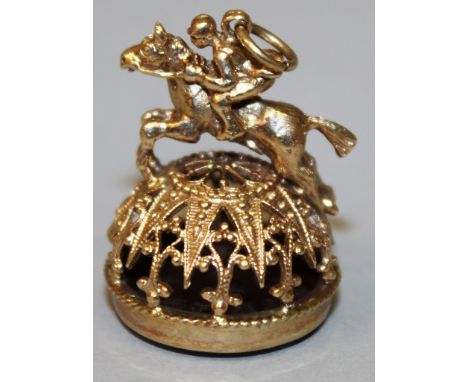 A 9CT GOLD "HUNTING" CIRCULAR SEAL, the top as a horse and rider, the base as a plain circular cornelian.