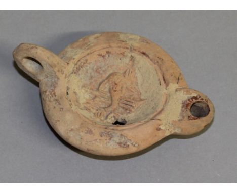 A ROMAN TERRACOTTA OIL LAMP. 4ins long.