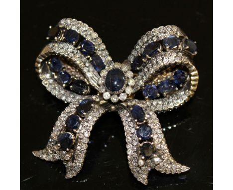 A SUPERB DIAMOND, SAPPHIRE AND CABOCHON SAPPHIRE BOW BROOCH set in white and yellow gold.