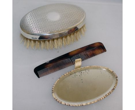 A TRAVELLING SET with silver back brush, a mirror and a comb.