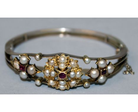A LOVELY SEED PEARL AND RUBY BANGLE set in gold.