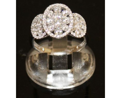 A GOOD TRIPLE DIAMOND OVAL PANEL RING, set with thirty small diamond, in 18ct white gold.