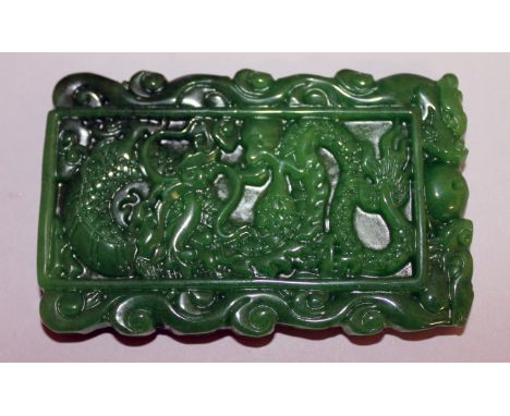 A CARVED CHINESE JADE RECTANGULAR TABLET. 9cms x 5.5cms.