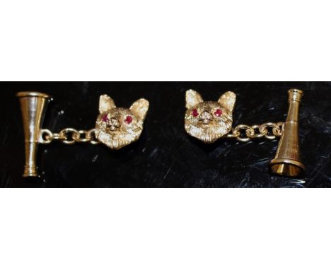 A PAIR OF 9CT GOLD HUNTING CUFFLINKS with ruby eyes.